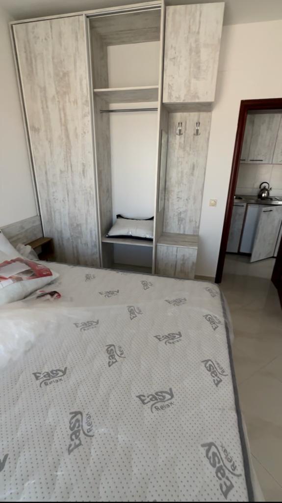 Modern Ulcinj bedroom with cozy bed, wardrobe, kitchen access&mdash;prime Montenegro real estate by ekosphere doo at montenegro-listings.me.