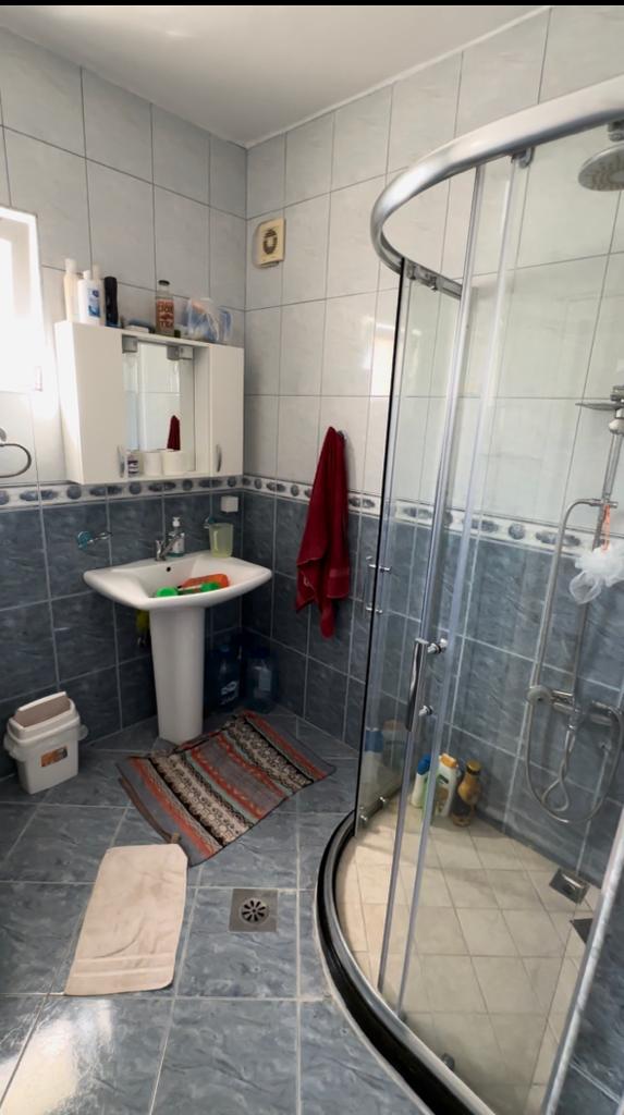 Modern Ulcinj bathroom with blue and white tiles, glass shower, sleek sink&mdash;prime real estate. Find more on montenegro-listings.me by ekosphere doo.