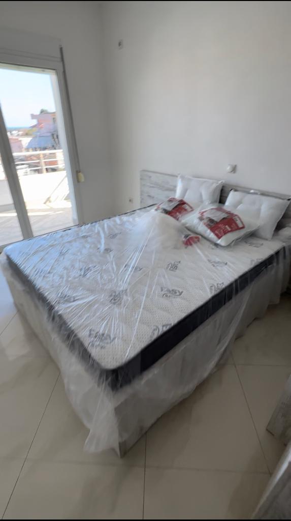 Modern double bedroom with stunning Ulcinj views, stylish tile floors, and chic decor&mdash;exclusive at Montenegro-Listings.me by Ekosphere doo.