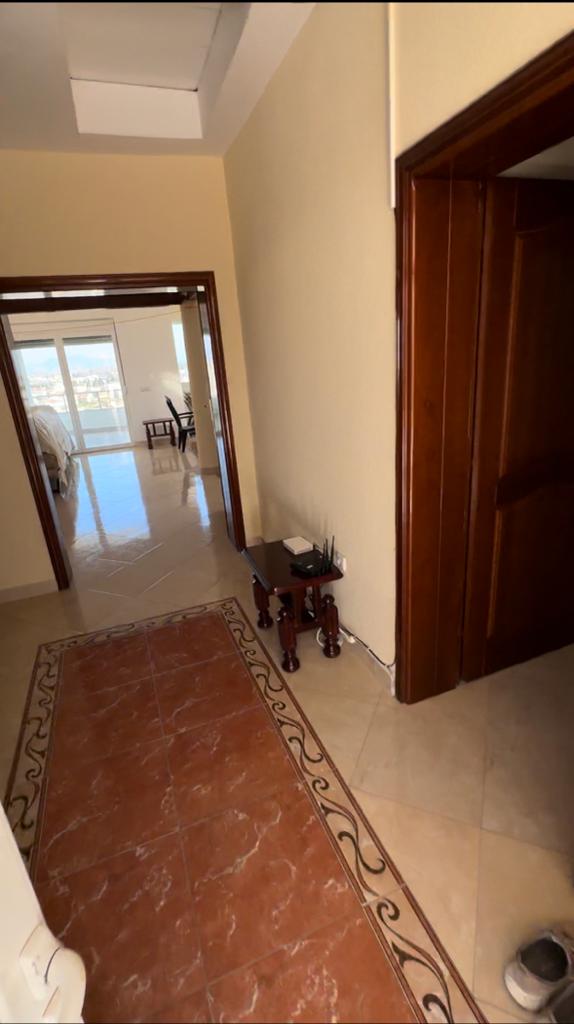 Bright hallway with beige walls and tile floors leads to a sunlit Ulcinj bedroom; ideal Montenegro property on montenegro-listings.me by ekosphere doo.