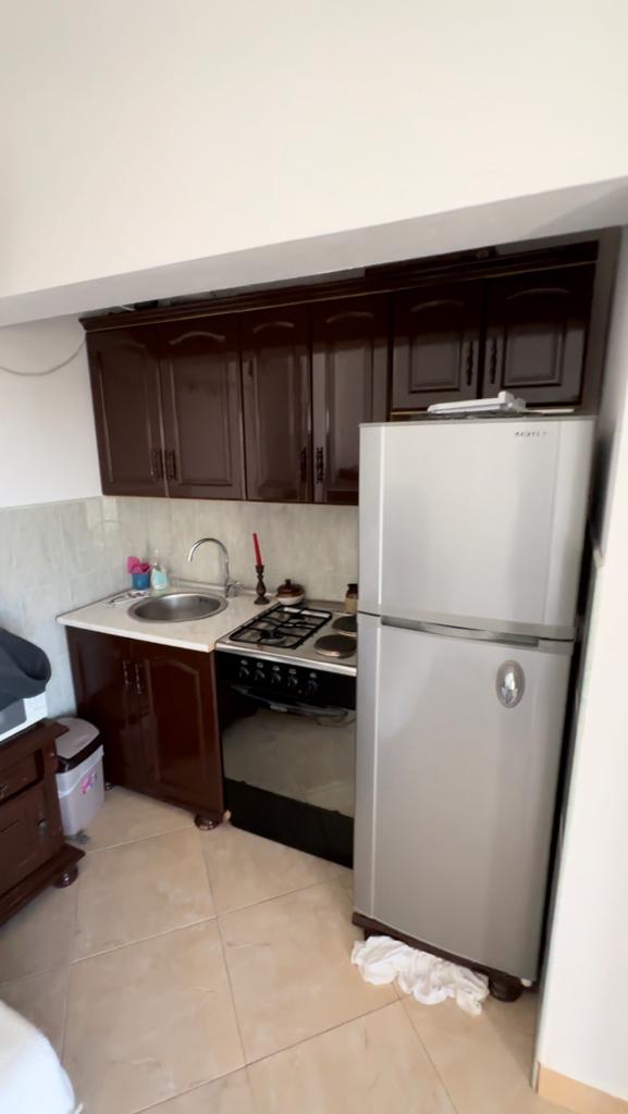 Modern kitchen in Ulcinj property: sleek dark cabinets, stainless fridge, gas stove. Invest via montenegro-listings.me by ekosphere doo.