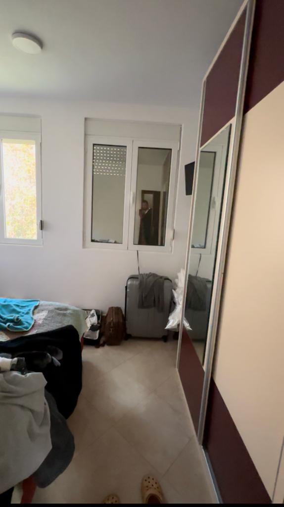 Charming Ulcinj bedroom with bed, mirrored wardrobe, and ample light&mdash;ideal Montenegro property investment on montenegro-listings.me by ekosphere doo.