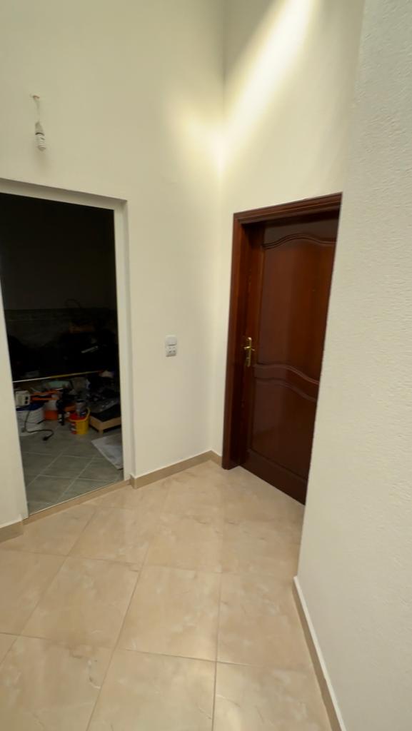 Spacious hallway with beige tiles and white walls in Ulcinj, Montenegro&mdash;exclusive property by montenegro-listings.me (EkoSphere DOO).