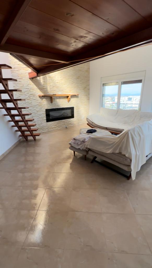 Luxury Ulcinj living room with stone accent wall, modern fireplace, floating stairs&mdash;exclusive on montenegro-listings.me by ekosphere doo.