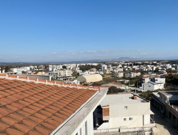 Stunning Ulcinj rooftop view: red-tiled roofs, white homes, pool & cityscape—prime real estate by ekosphere doo on montenegro-listings.me.