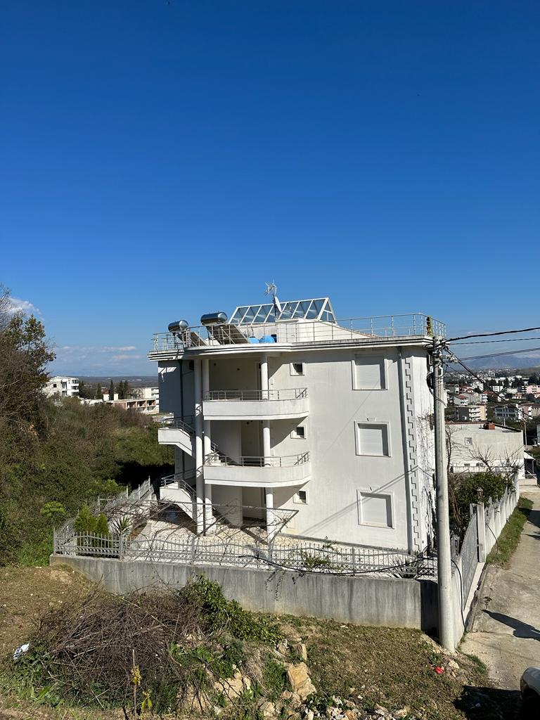 Modern four-story white building with balconies, solar panels, and lush greenery in Ulcinj&mdash;exclusive listing by ekosphere on montenegro-listings.me.