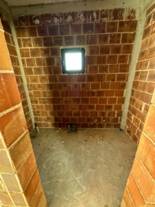 Unfinished room in Ulcinj, Montenegro with brick walls, concrete floor, and potential—exclusive at montenegro-listings.me by Ekosphere doo.