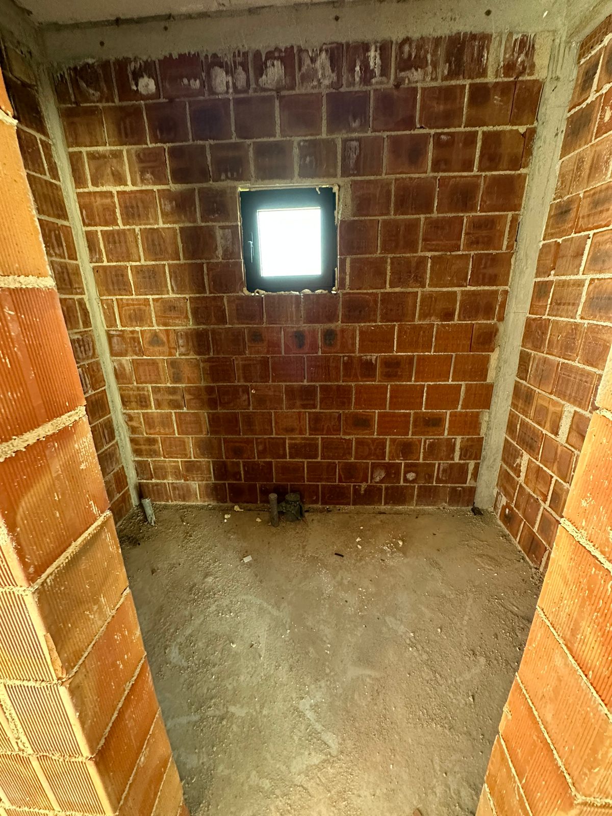 Unfinished room in Ulcinj, Montenegro with brick walls, concrete floor, and potential&mdash;exclusive at montenegro-listings.me by Ekosphere doo.