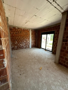 Spacious unfinished room in Ulcinj, Montenegro. Brick walls, concrete floor, sliding glass door. Exclusive on montenegro-listings.me by Ekosphere DOO.