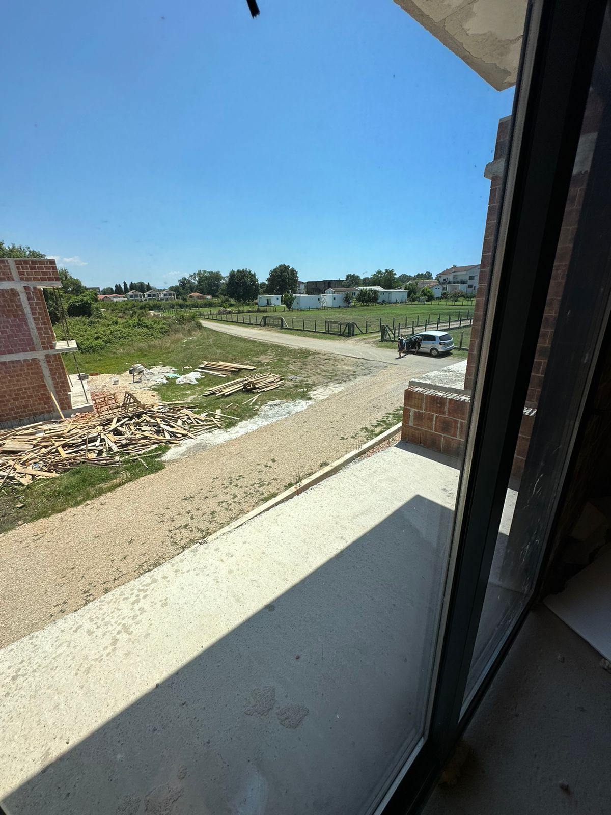 Panoramic Ulcinj, Montenegro property view: development site, road access, lush fields, and prime real estate. Eksosphere doo project.