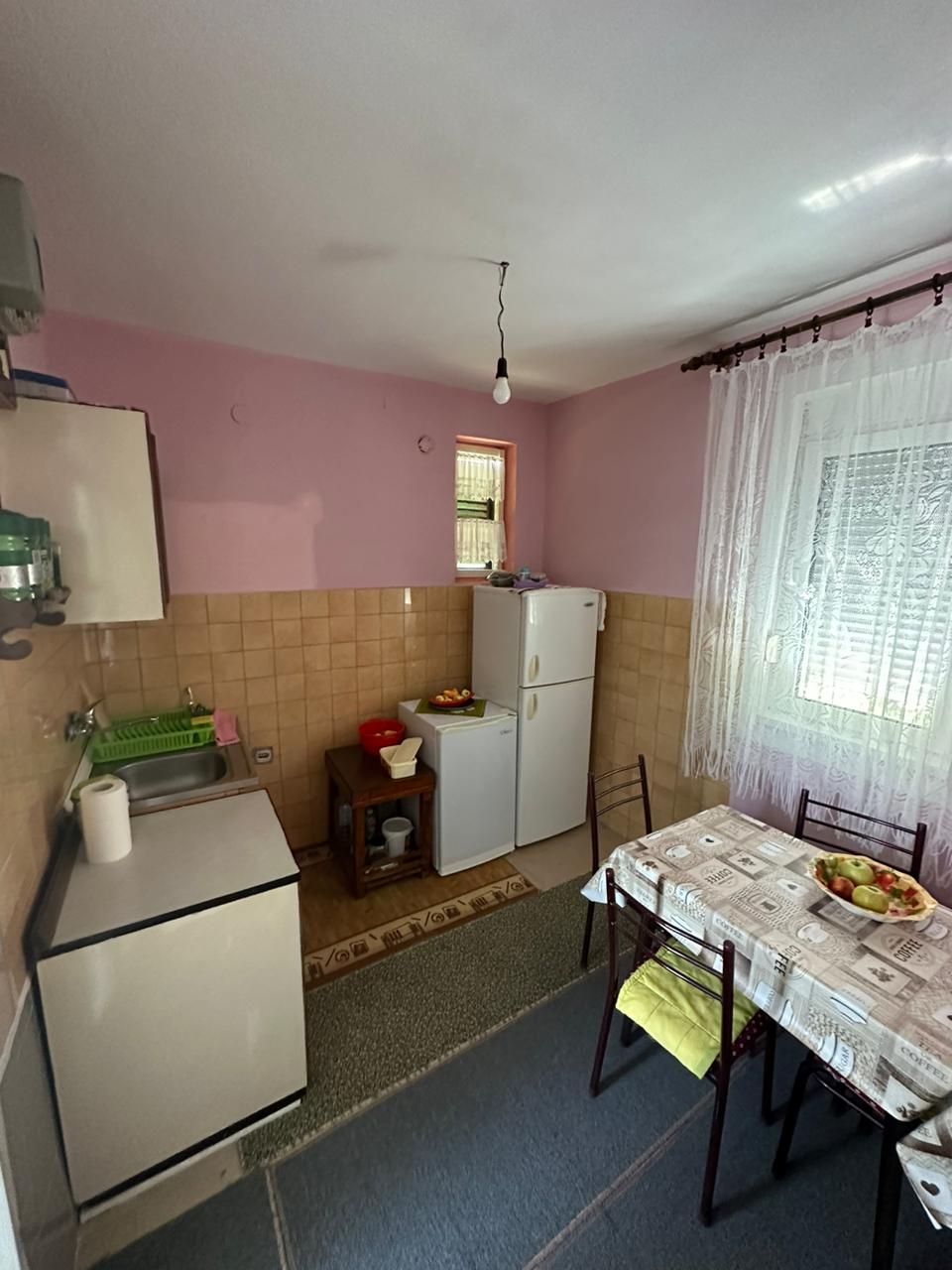 Charming Ulcinj kitchen with pink walls, brown tiles, appliances, dining set&mdash;ideal investment. Exclusive at montenegro-listings.me by ekosphere doo.