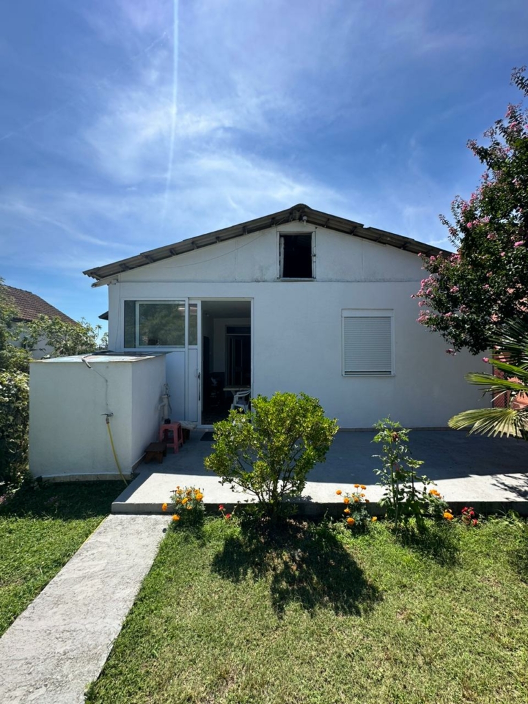 Charming white house in Ulcinj, Montenegro with patio, garden, and lawn—ideal for investment. Listed by ekosphere doo on montenegro-listings.me.