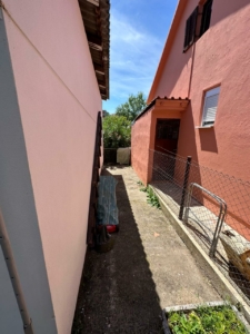 Charming Ulcinj investment: concrete pathway between pink properties, fenced garden. Exclusive on montenegro-listings.me by ekosphere doo.