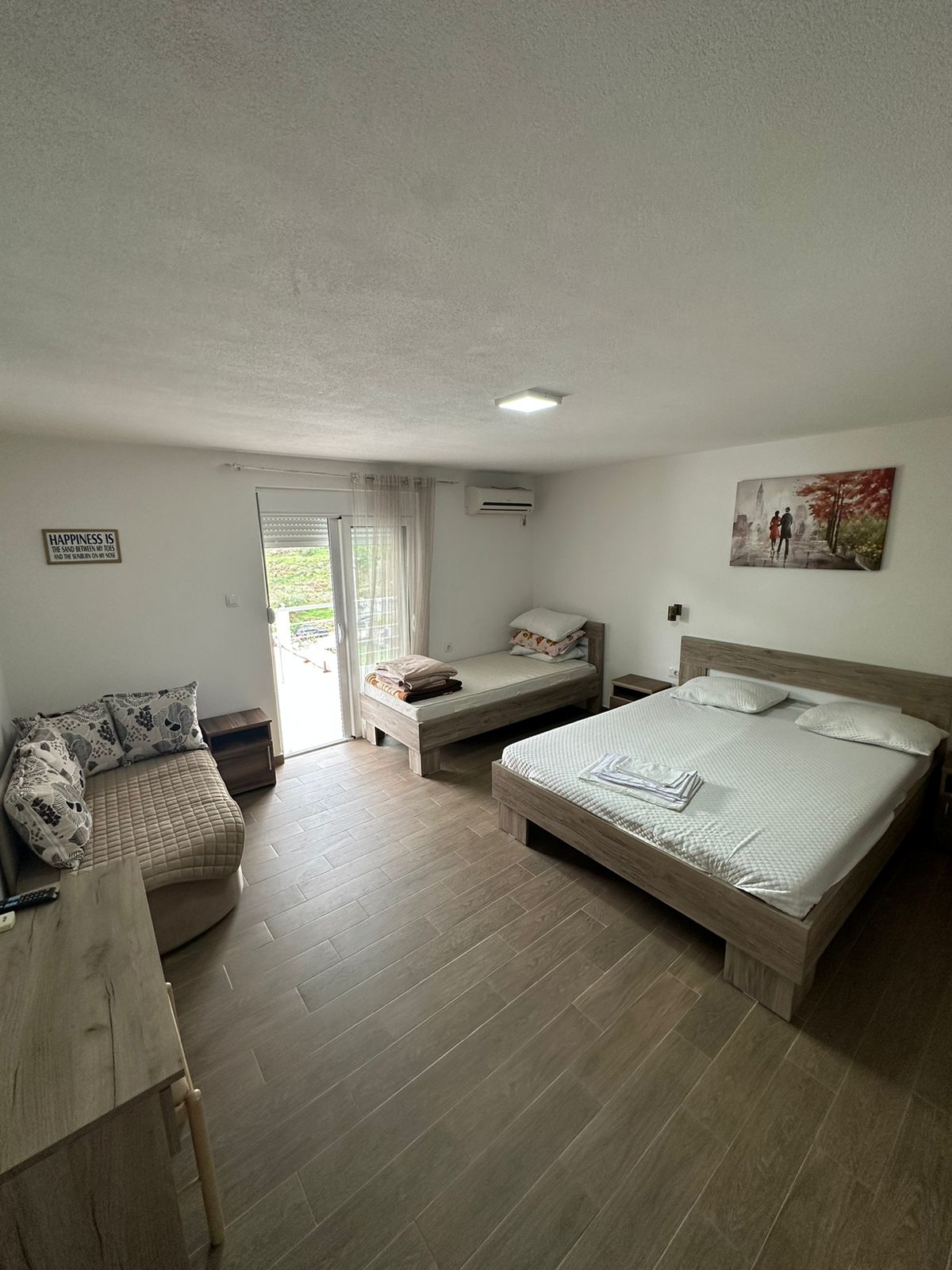 Bright, furnished Ulcinj bedroom with beds, sofa, desk & scenic views&mdash;prime investment via montenegro-listings.me by Ekosphere Doo.