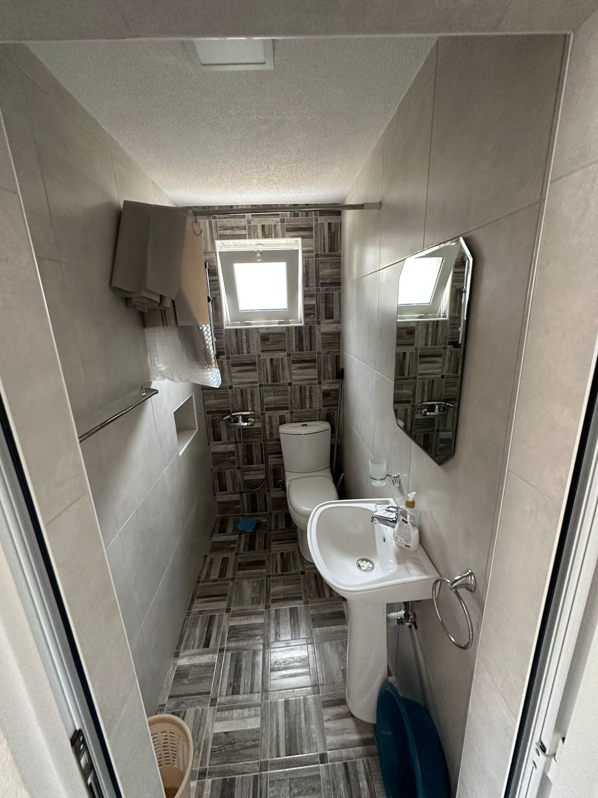 Modern tiled bathroom featuring natural light, quality fixtures, ideal for Ulcinj Montenegro real estate on montenegro-listings.me by Ekosphere.