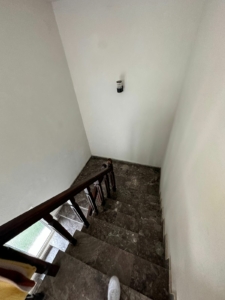 Elegant dark marble staircase with wood handrail in Ekosphere DOO Ulcinj property—ideal Montenegro investment via montenegro-listings.me.