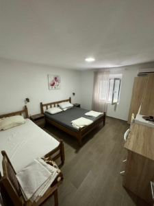 Bright Ulcinj bedroom with double & single bed, wardrobe, desk, window—prime investment via montenegro-listings.me by Ekosphere.