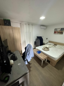 Bright Ulcinj bedroom with spacious bed, desk, wardrobe & sunlit curtains—prime property at montenegro-listings.me by Ekosphere doo.