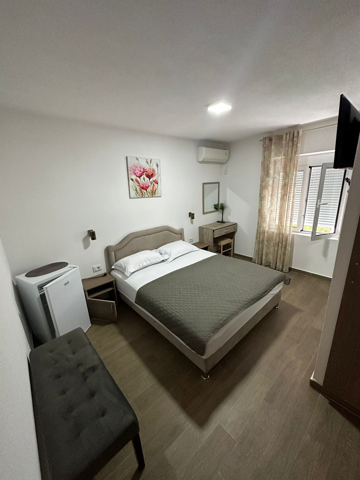 Modern hotel room in Ulcinj: double bed, desk, AC, TV&mdash;perfect Montenegro property investment via montenegro-listings.me by ekosphere doo.