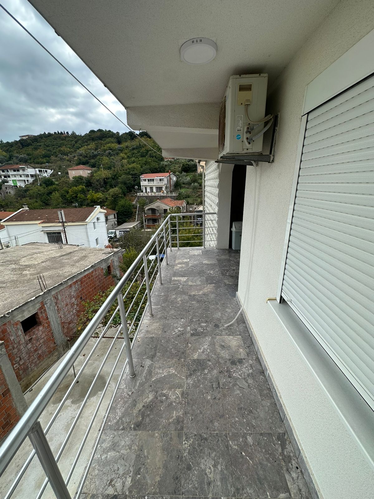 Stylish tiled balcony with metal railing, AC, and scenic Ulcinj views&mdash;ideal Montenegro investment via montenegro-listings.me by ekosphere doo.