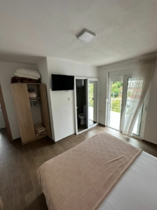 Elegant Ulcinj, Montenegro bedroom with balcony, lush views. Invest via montenegro-listings.me by Ekosphere doo—prime real estate!.