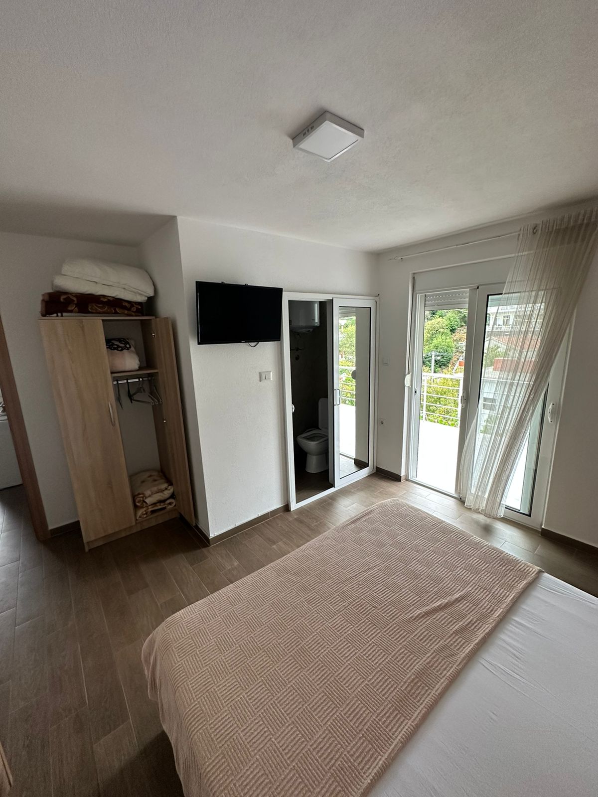 Elegant Ulcinj, Montenegro bedroom with balcony, lush views. Invest via montenegro-listings.me by Ekosphere doo&mdash;prime real estate!.