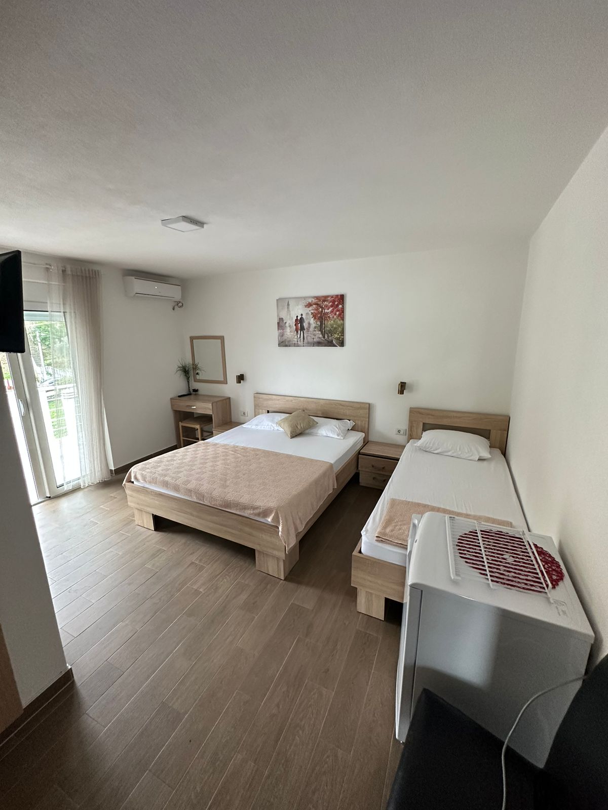 Modern Ulcinj hotel room with two beds, bright natural light, TV, fridge&mdash;prime investment. Ekosphere doo, montenegro-listings.me.
