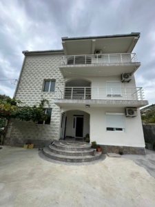 Modern three-story home in Ulcinj, Montenegro with balconies, AC units, and charming entry—ideal real estate by ekosphere doo.
