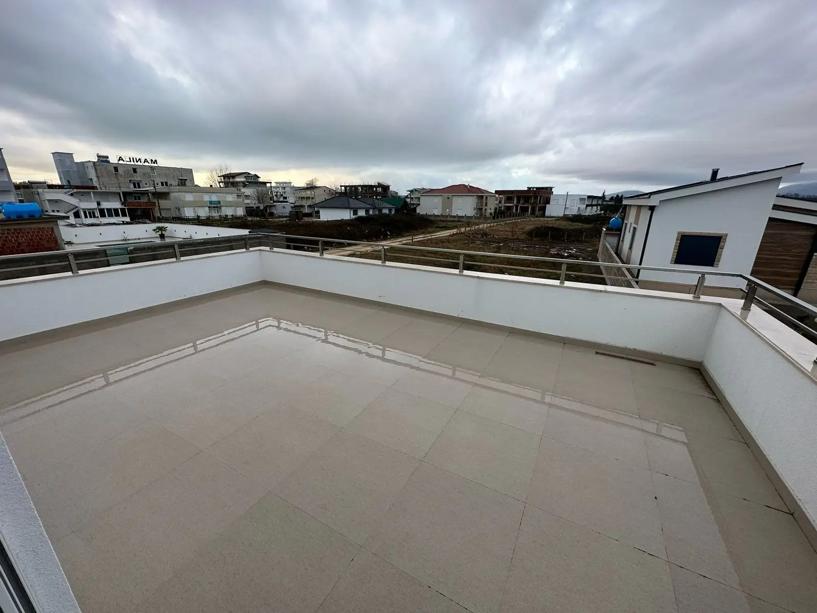 Spacious rooftop terrace with elegant tiles and modern railings, offering panoramic Ulcinj views—prime real estate at montenegro-listings.me by ekosphere doo.