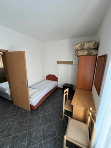 Cozy Ulcinj room for sale: single bed, desk, wardrobe, tiled floor, access to extra space. Great investment via montenegro-listings.me by Ekosphere Doo.