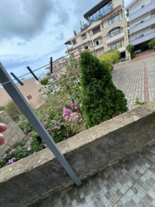 Charming Ulcinj property with lush garden, pink flowers, paved drive, scenic apartments—top Montenegro investment via ekosphere doo.