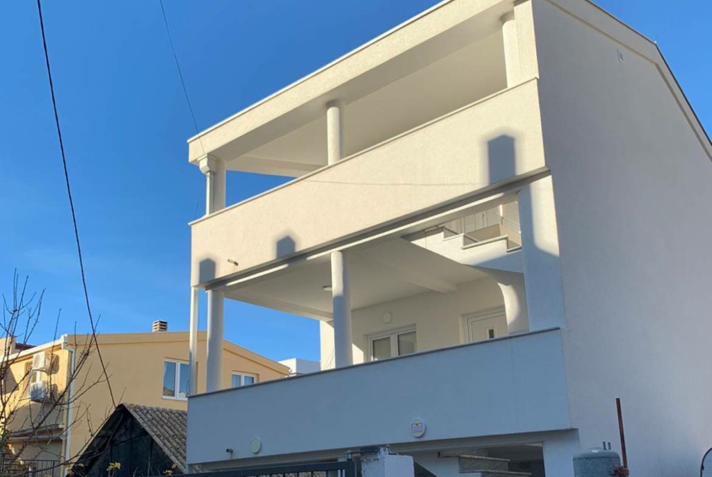 Contemporary white two-story property with balconies in Ulcinj, Montenegro—ideal investment. Listed by montenegro-listings.me (Ekosphere doo).