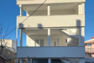 Elegant three-story white property with balconies, pillars, and spiral staircase in sunny Ulcinj. Exclusive on montenegro-listings.me by ekosphere doo.