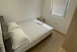 Charming Ulcinj bedroom with double bed, bright floors, and modern touches—ideal Montenegro real estate by montenegro-listings.me/ekosphere.