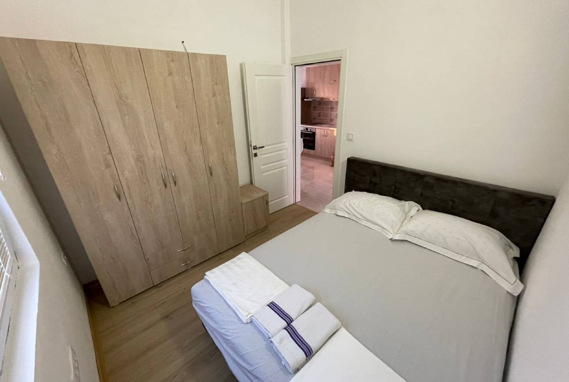 Charming Ulcinj Montenegro property: stylish small bedroom with wood floors, double bed, wardrobe&mdash;ideal investment at montenegro-listings.me by ekosphere doo.