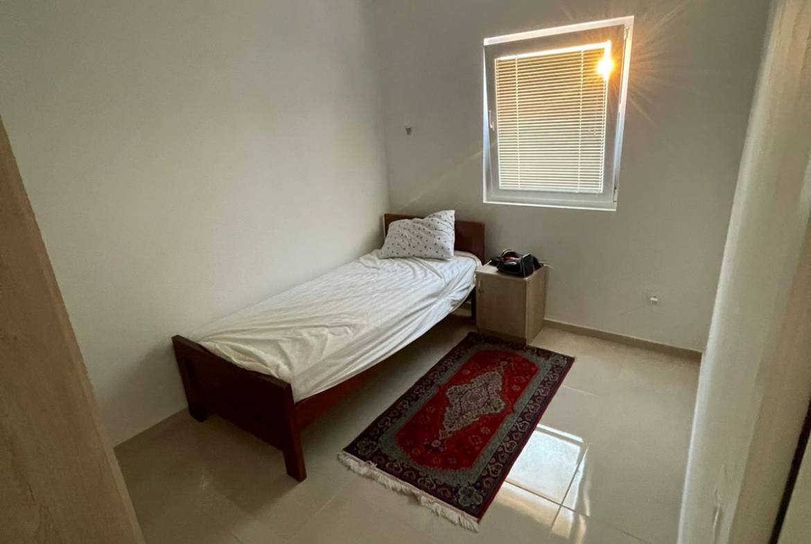 Charming Ulcinj bedroom with natural light, modern accents, ideal Montenegro property investment. Listed on montenegro-listings.me by ekosphere doo.