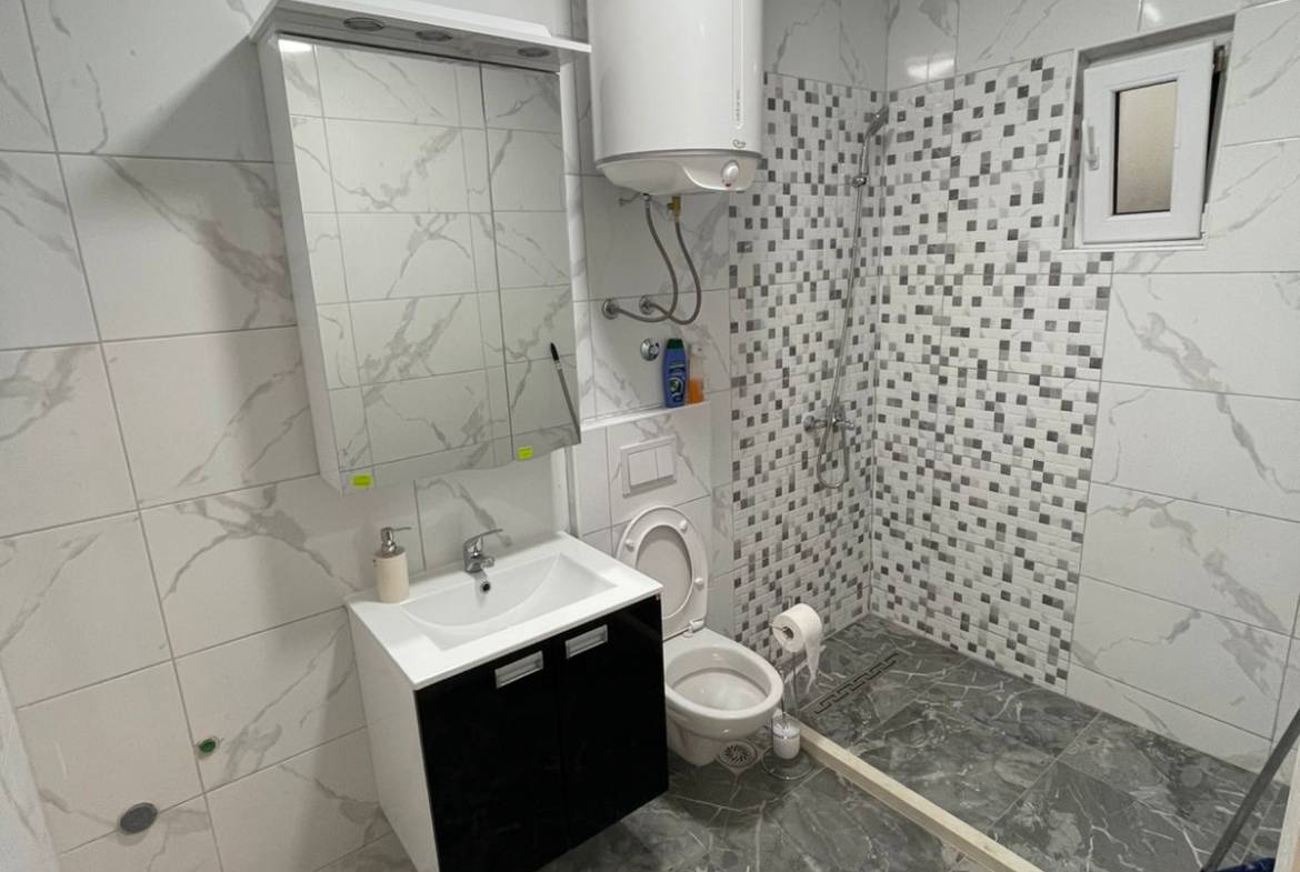 Modern Ulcinj bathroom with marble tile, luxury fixtures, and mosaic shower&mdash;prime real estate by montenegro-listings.me (ekosphere doo).