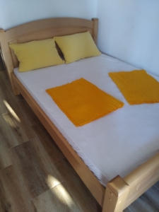 Bright Ulcinj apartment with wooden bed, modern finishes, ideal Montenegro real estate investment. Listed on montenegro-listings.me by Ekosphere doo.