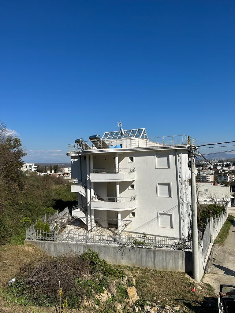 Modern four-story white building with balconies and rooftop, prime Ulcinj property for sale on montenegro-listings.me by Ekosphere.