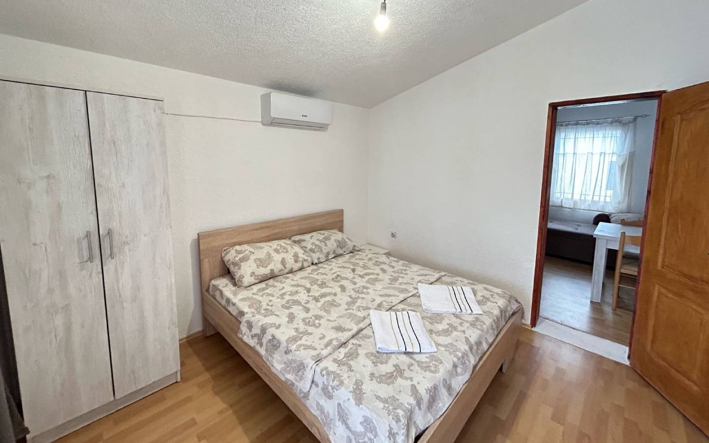 Discover a bright Ulcinj bedroom with double bed, AC, storage & modern comforts&mdash;prime Montenegro real estate by Ekosphere on montenegro-listings.me.