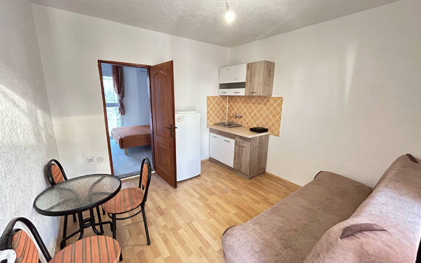 Stylish Ulcinj apartment: kitchenette, dining area, sofa, private bedroom. Top real estate investment via montenegro-listings.me/Ekosphere doo.