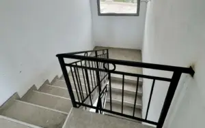 Modern concrete staircase with metal railings in Ulcinj property; investment potential—exclusive at Montenegro-Listings.me, by Ekosphere DOO.