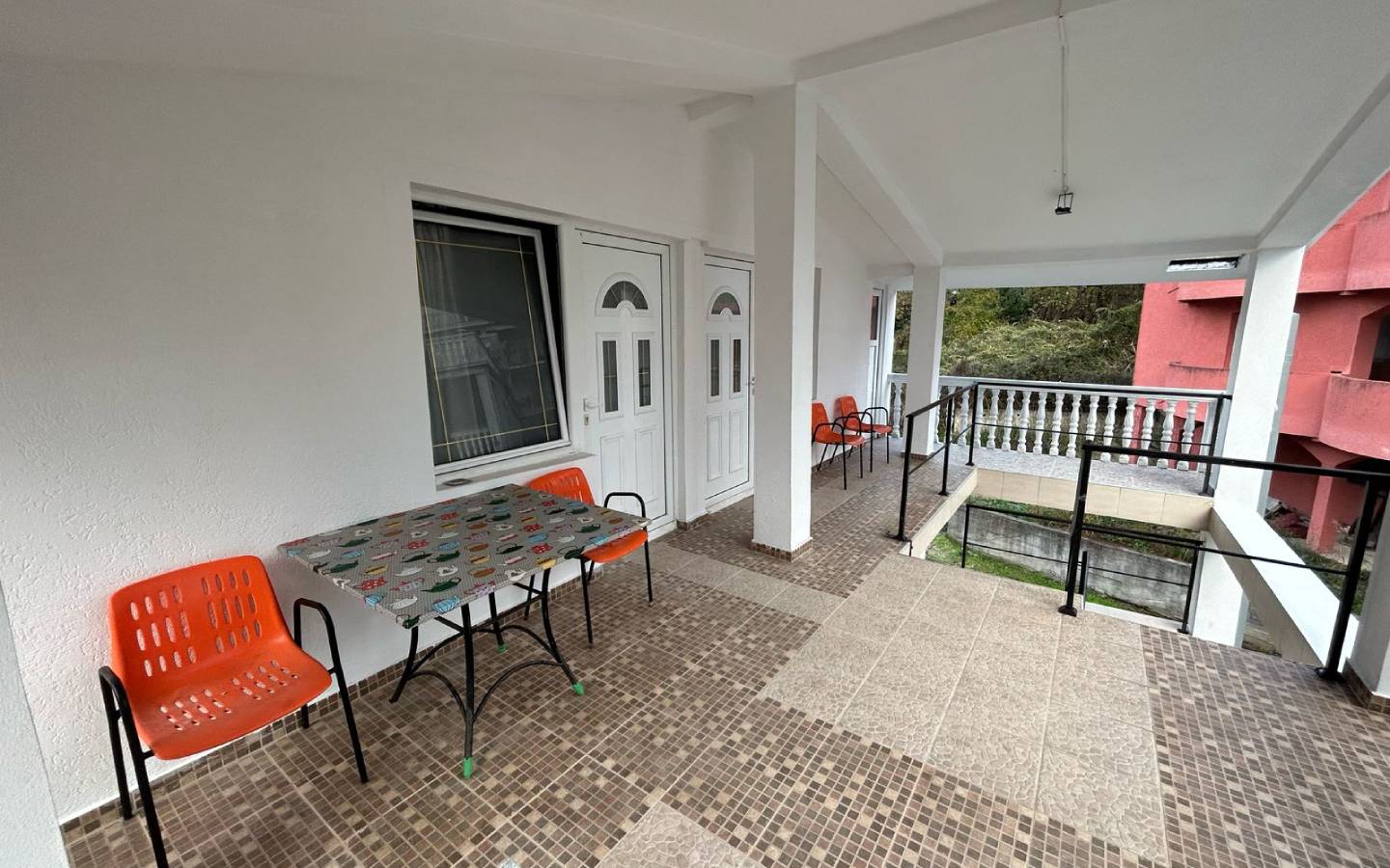 Stylish covered patio in Ulcinj, Montenegro&mdash;tiled floors, modern seating, ideal property investment on montenegro-listings.me by ekosphere doo.