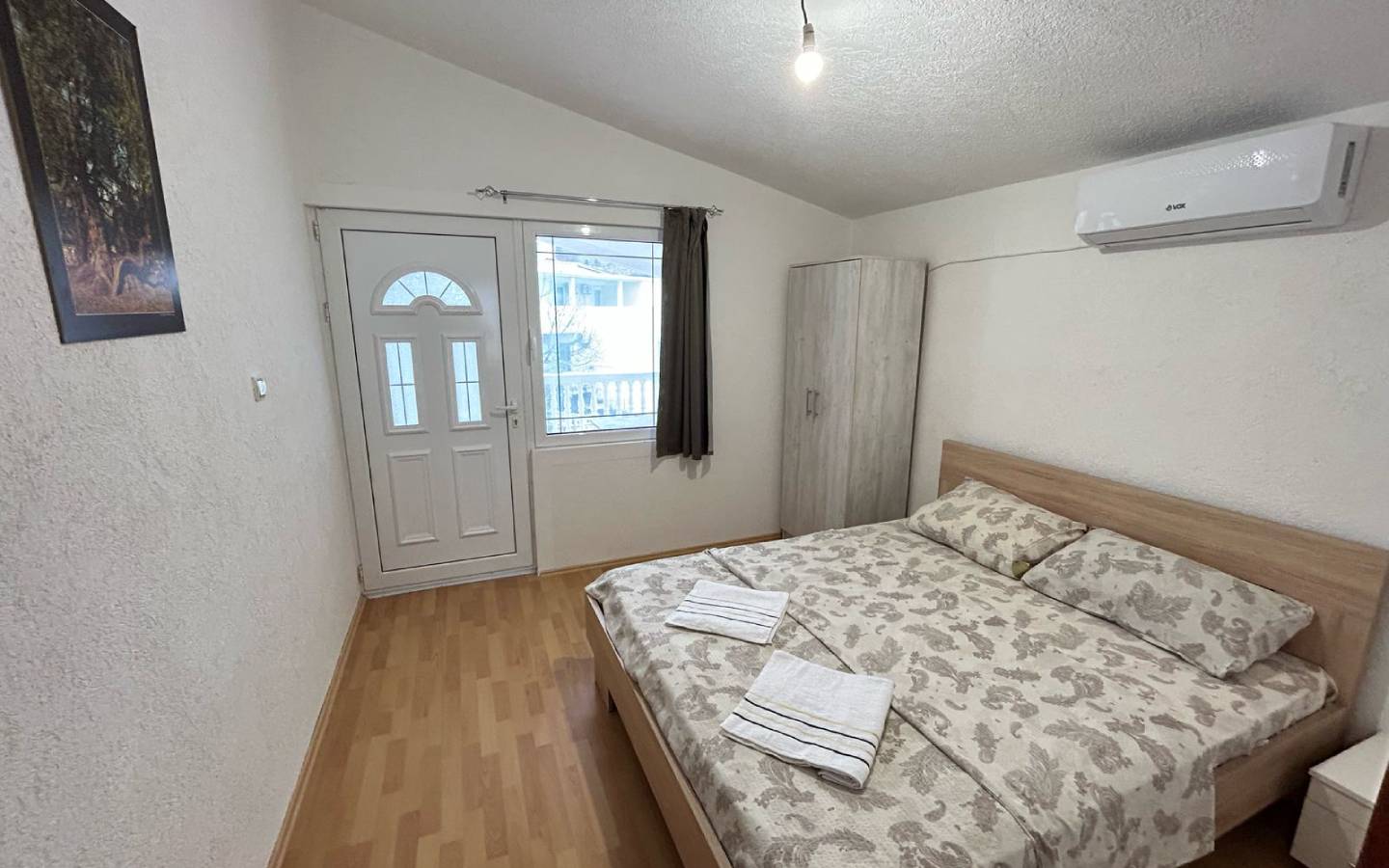 Charming Ulcinj bedroom for sale: double bed, AC, wardrobe, bright windows&mdash;prime Montenegro real estate via montenegro-listings.me.