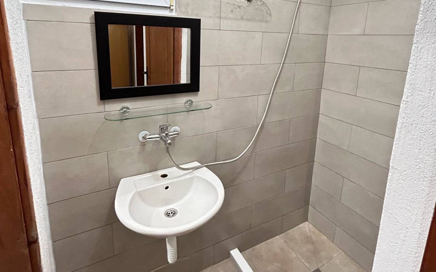 Elegant Ulcinj bathroom with modern fixtures, beige tile, and stylish details&mdash;exclusive on montenegro-listings.me by Ekosphere doo.