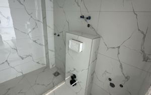 Under-construction Ulcinj bathroom with elegant marble tiles, premium fixtures—exclusive real estate by Ekosphere at montenegro-listings.me.