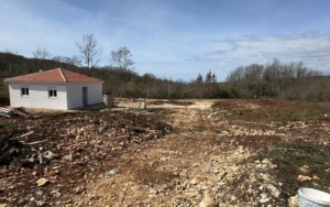 Charming white single-story house with red-tiled roof on a cleared plot in Ulcinj, Montenegro—ideal property investment. By ekosphere doo.