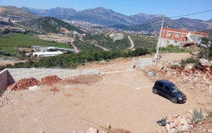 Prime Ulcinj, Montenegro investment: half-built home, gravel parking, mountain views. Listed by montenegro-listings.me (ekosphere doo).