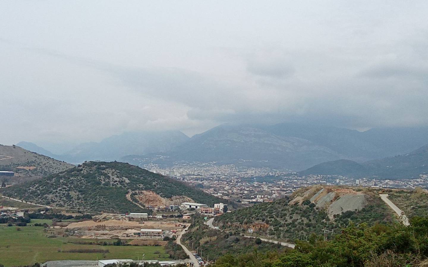 Panoramic view of Ulcinj’s prime properties amid hills, greenery, and urban growth—exclusive listings at Montenegro-listings.me by Ekosphere DOO.