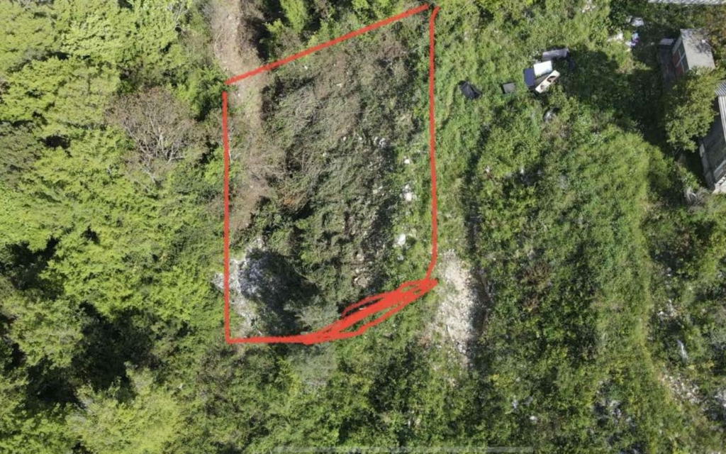 Prime real estate plot in Ulcinj, Montenegro—outlined area amid lush greenery. Investment potential via montenegro-listings.me (ekosphere doo).